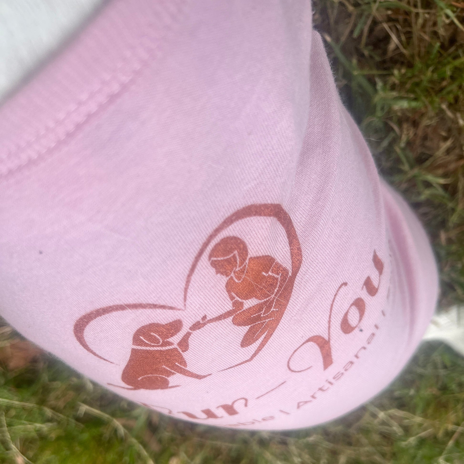 close up of print slightly angled in Copper print for Fur-You logo on Dusty Pink Tee