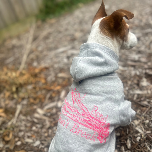 Charlie shows off the back view of Fur-You’s ‘Bend Don’t Break’ hoodie in glow pink on grey marle. The artistic print stands out against the fabric, perfectly suited for stylish pups