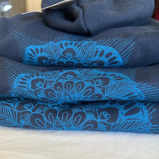 Close-up detail of hand-printed mandala design on blue dog hoodie