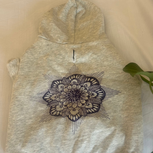 A flat lay of the purple hoodie with the hood up, highlighting the D-ring feature inside the hoodie. This design detail allows for easy attachment of a leash, making it both practical and stylish. The soft fabric, made from eco-friendly materials, offers comfort for pets while emphasising sustainability and functionality.