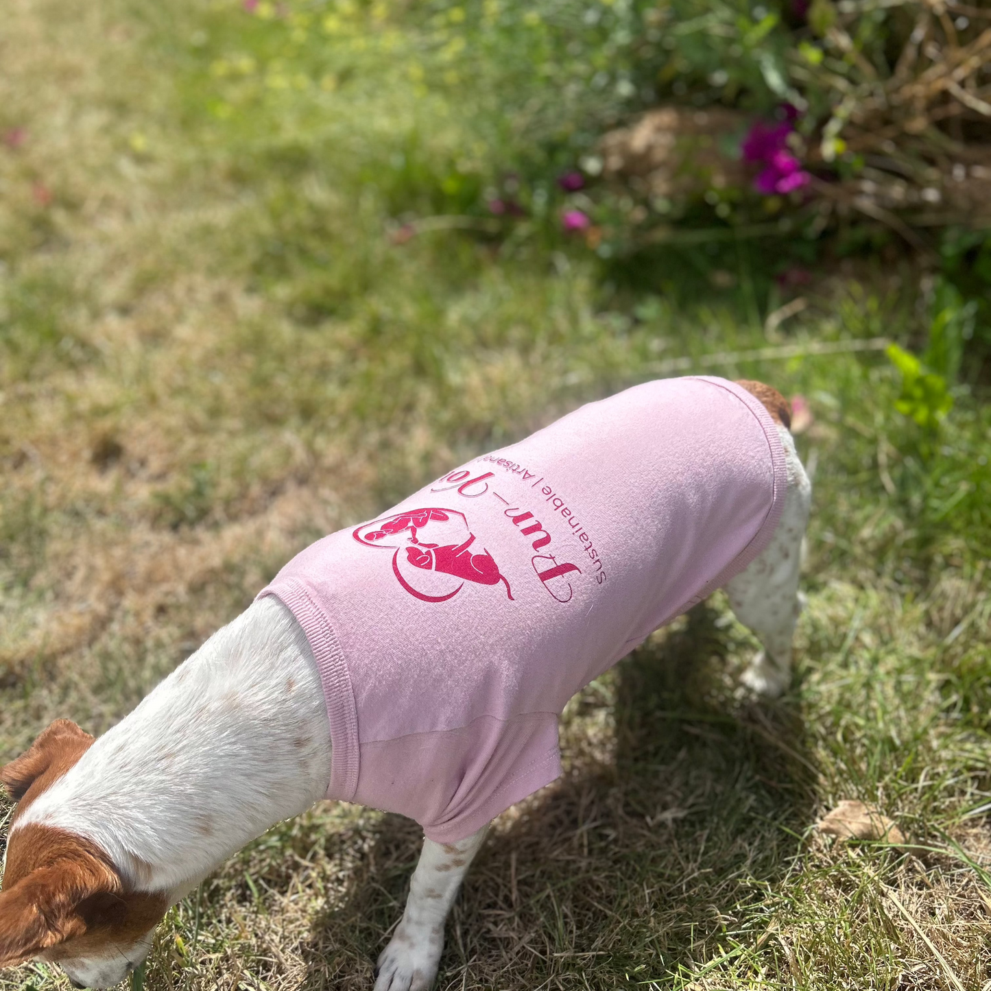 standing in front of bushes at an angle with clear back view of Bordeaux printed Fur-You logo