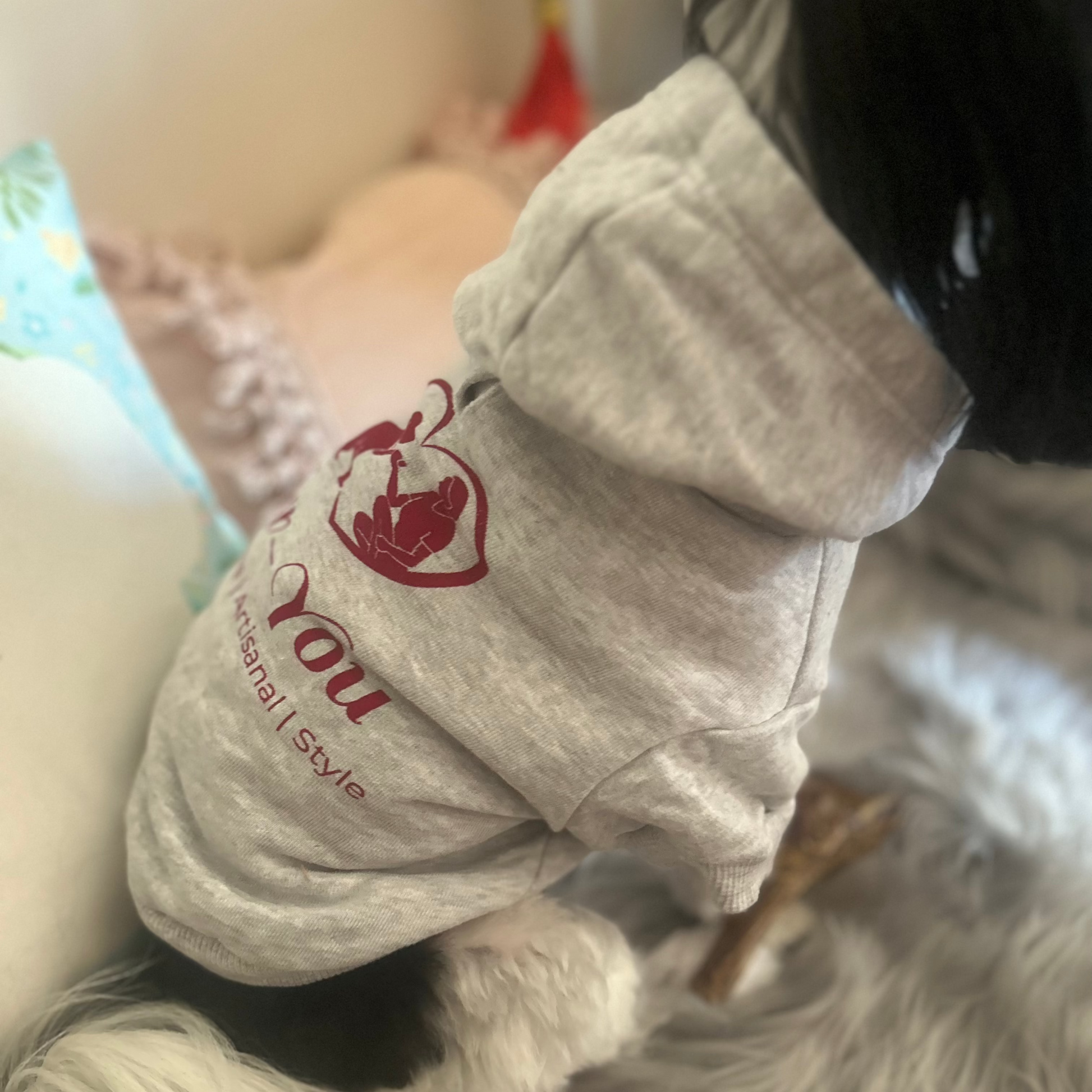 Clara sits with a gentle angle, revealing Fur-You’s artisan screen-printed logo on her grey marle hoodie. A subtle yet stylish way to wear her values—sustainability, artistry, and timeless design