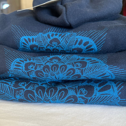Close-up detail of hand-printed mandala design on blue dog hoodie